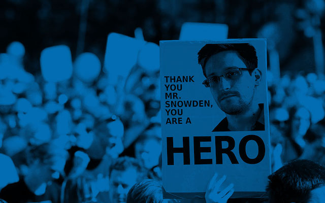 Sign with Snowden's face reads 'Thank you Mr. Snowden, you are a hero'