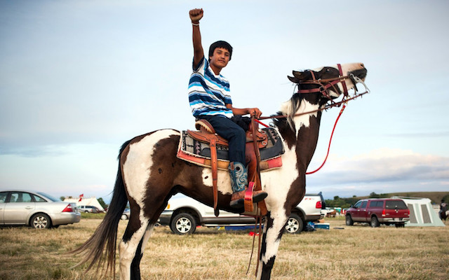 Boy on a horse with a raised fist